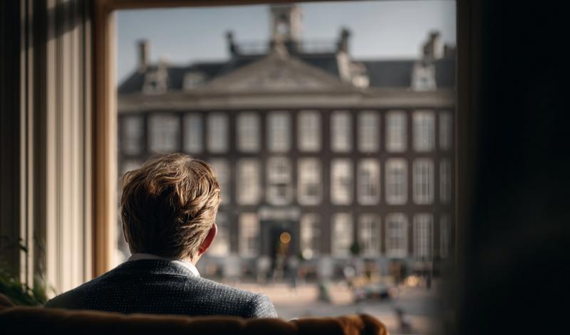 Man uit raam kijkend.jpg